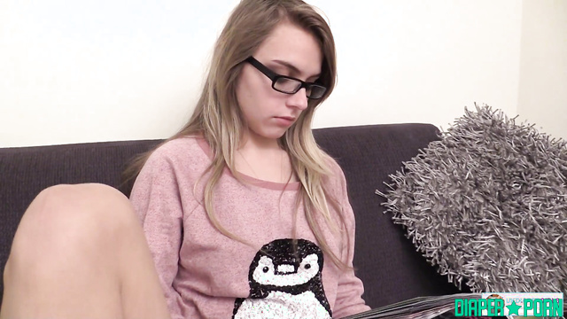 Blonde in glasses pissing loud while reading - UKDiaperGirls