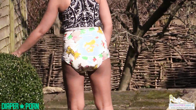 Brunette in diaper squatting outdoors, panting - UKDiaperGirls
