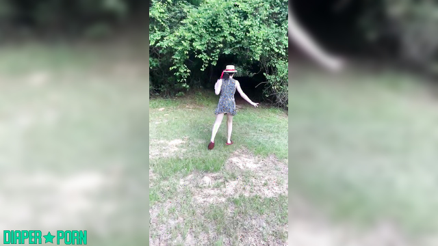 Brunette squatting wet in diaper outdoors - LittleDiaperIdol