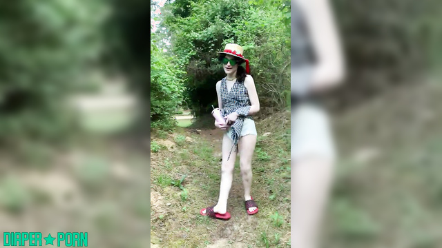 Brunette squatting wet in diaper outdoors - LittleDiaperIdol