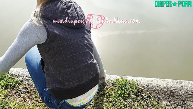 Blonde walking outdoors with visible diaper bulge - TinkerNina