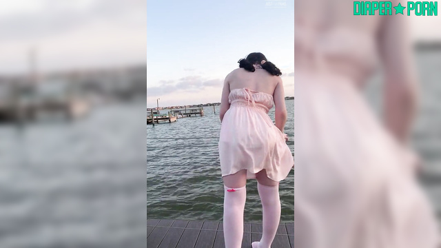 Brunette teasing outdoors, diaper hidden under dress - LittleDiaperIdol