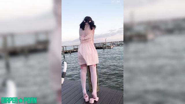 Brunette teasing outdoors, diaper hidden under dress - LittleDiaperIdol