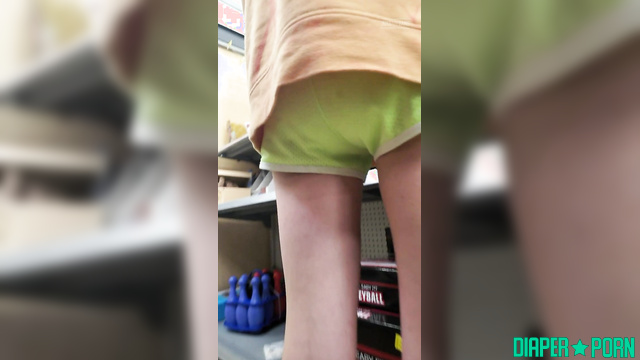 Brunette squatting wide, diaper peeking under shorts outdoors - BabyFluffyBunny