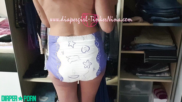 Brunette fingers pressing pampers snug - TinkerNina