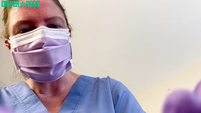 Gloved hands press while mask gags during diaper change - Sierra Loren