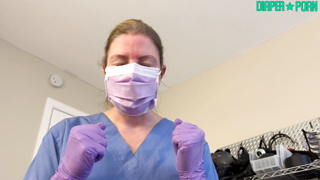 Gloved hands press while mask gags during diaper change - Sierra Loren